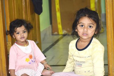 Portrait of girls sitting at home