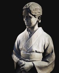 Close-up of statue against black background