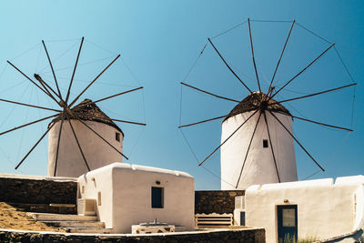 Low angle view of windmills