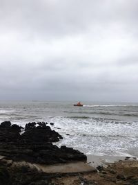 Scenic view of sea against cloudy sky