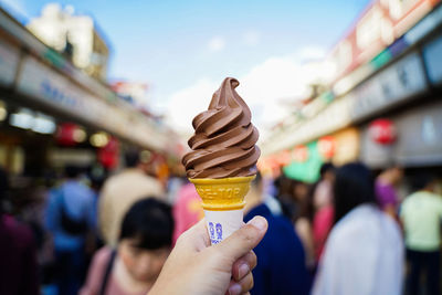 Hand holding ice cream cone