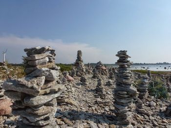 Stack of rocks on land against sky