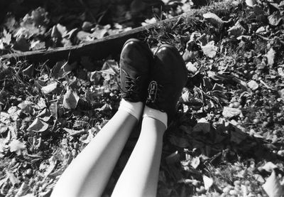 Low section of woman lying on ground