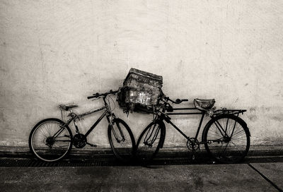 Bicycles parked against wall