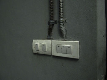 Close-up of telephone booth on wall