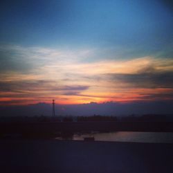 Scenic view of landscape against sky at sunset