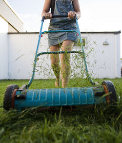 Woman mowing lawn