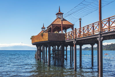 Pier over sea against clear sky