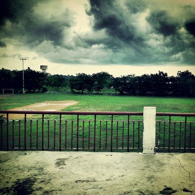 sky, cloud - sky, fence, grass, cloudy, field, landscape, cloud, tranquility, tranquil scene, nature, grassy, protection, tree, scenics, safety, green color, weather, beauty in nature, railing