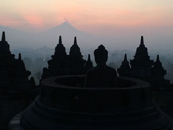 Silhouette of temple against sky during sunset
