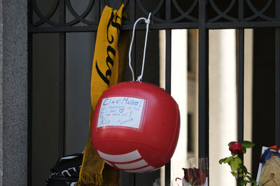 Close-up of red heart shape hanging on window