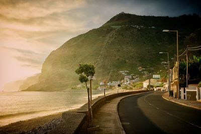 Road by sea against sky