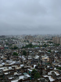 High angle view of buildings in city against sky