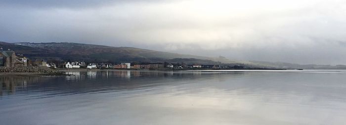 Scenic view of lake against sky during winter