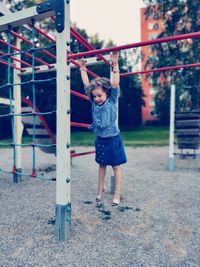Full length of woman standing on slide in playground