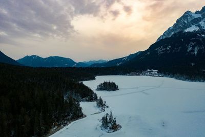 Scenic view of snowcapped mountains against sky during sunset