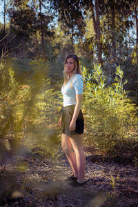 Full length portrait of woman in forest
