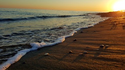 Scenic view of beach against sky during sunset