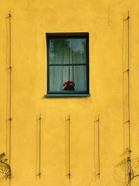 Closed window of yellow building