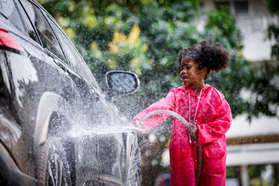 Full length of man in wet car