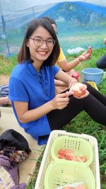 Smiling young woman holding ice cream