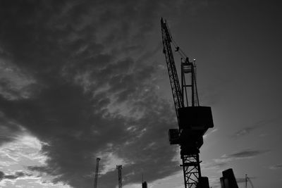 Low angle view of crane against sky