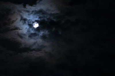 Low angle view of moon in cloudy sky