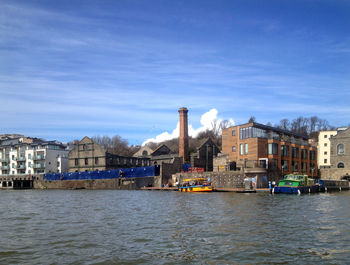 River view with built structures against blue sky