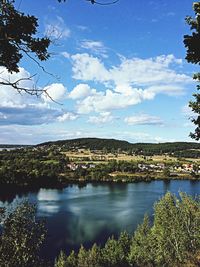 Scenic view of lake against cloudy sky