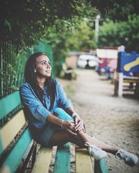 Portrait of young woman sitting outdoors