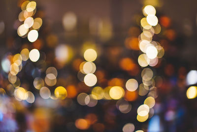 Defocused image of illuminated christmas lights at night