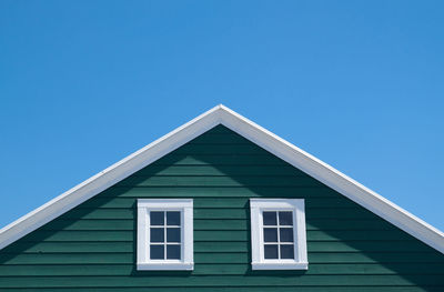 Facade of house against clear blue sky