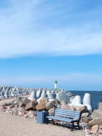 Chairs on beach against sky