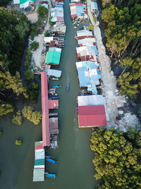 High angle view of river amidst trees and buildings