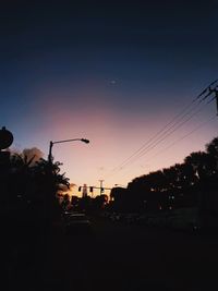 Cars on street at sunset