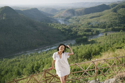 Full length of woman standing on mountain