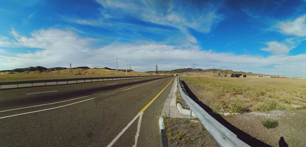 Empty road along countryside landscape