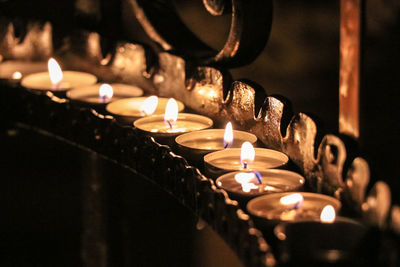 Close-up of tea light candles in temple