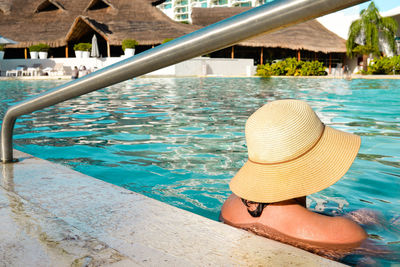 Man relaxing in swimming pool at beach