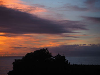 Scenic view of dramatic sky over sea during sunset