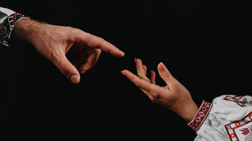 Close-up of hand against black background