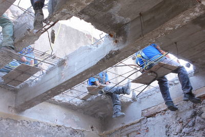 Low angle view of construction workers at incomplete building