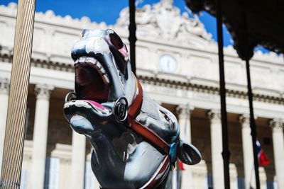 Close-up of horse statue against building