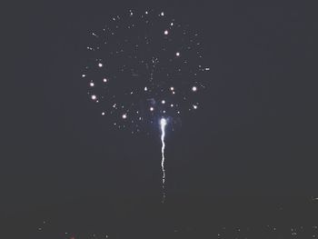 Low angle view of firework display at night