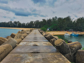 Pier over lake against sky