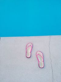 High angle view of flip-flop by swimming pool