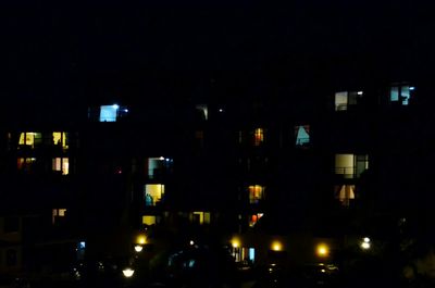 Illuminated city against sky at night