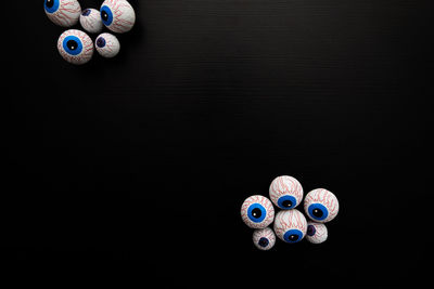 Funny halloween treat - candy eyeballs on dark background. copy space