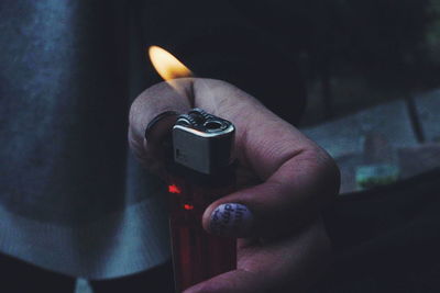 Close-up of hand holding lighter