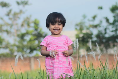 Cute girl smiling on field